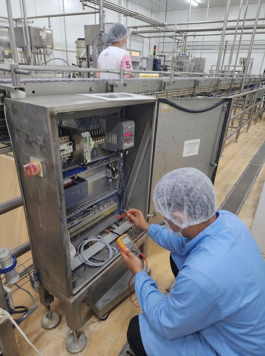 MechaTrade technician working on a plant control panel